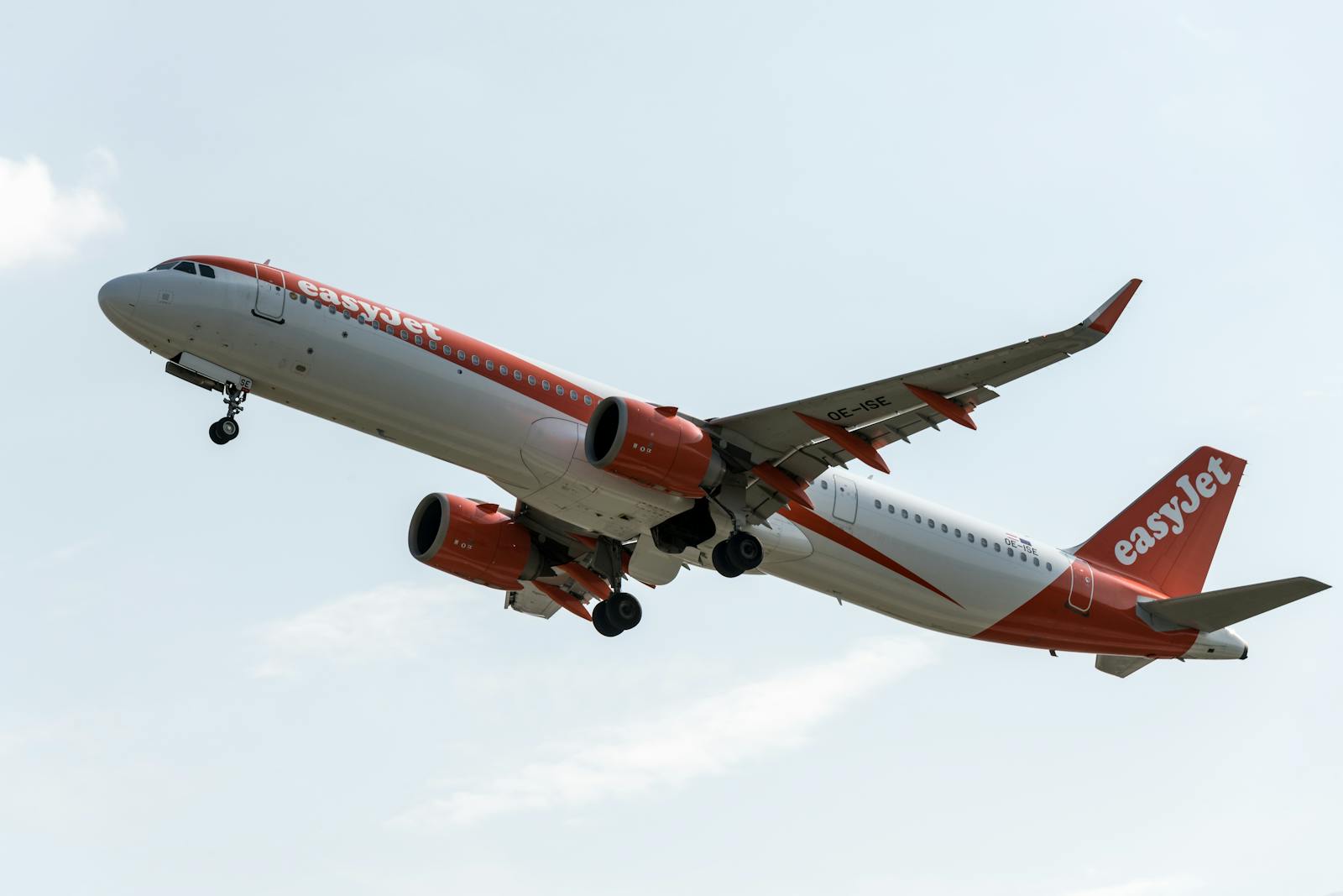 An EasyJet airplane takes off from Prague airport on a clear day, showcasing modern aviation and travel.