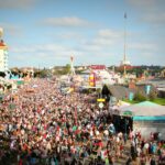 A lively scene at Oktoberfest in Munich with a massive crowd enjoying the festivities and attractions.
